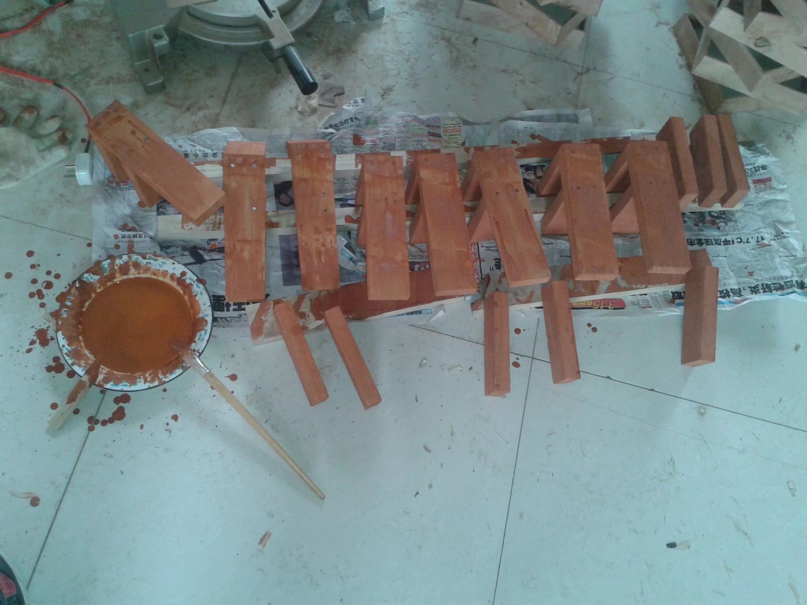 Freshly painted wooden brackets drying before installation